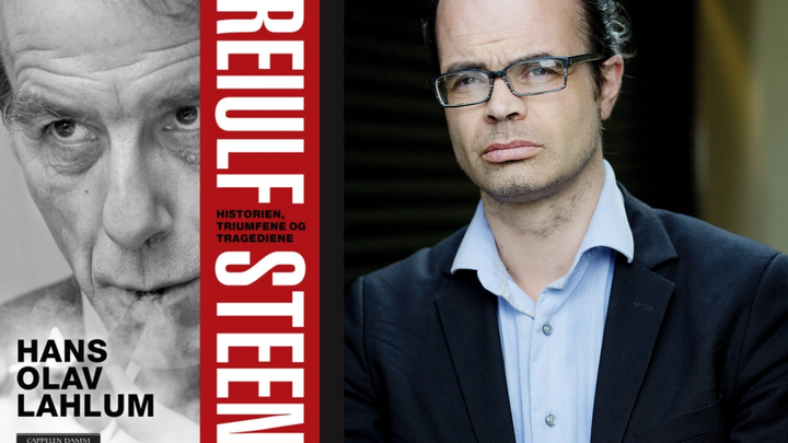 Mann med briller, mørk blazer og blå skjorte. Ved siden av en bok med bilde av Reiulf Steen. 